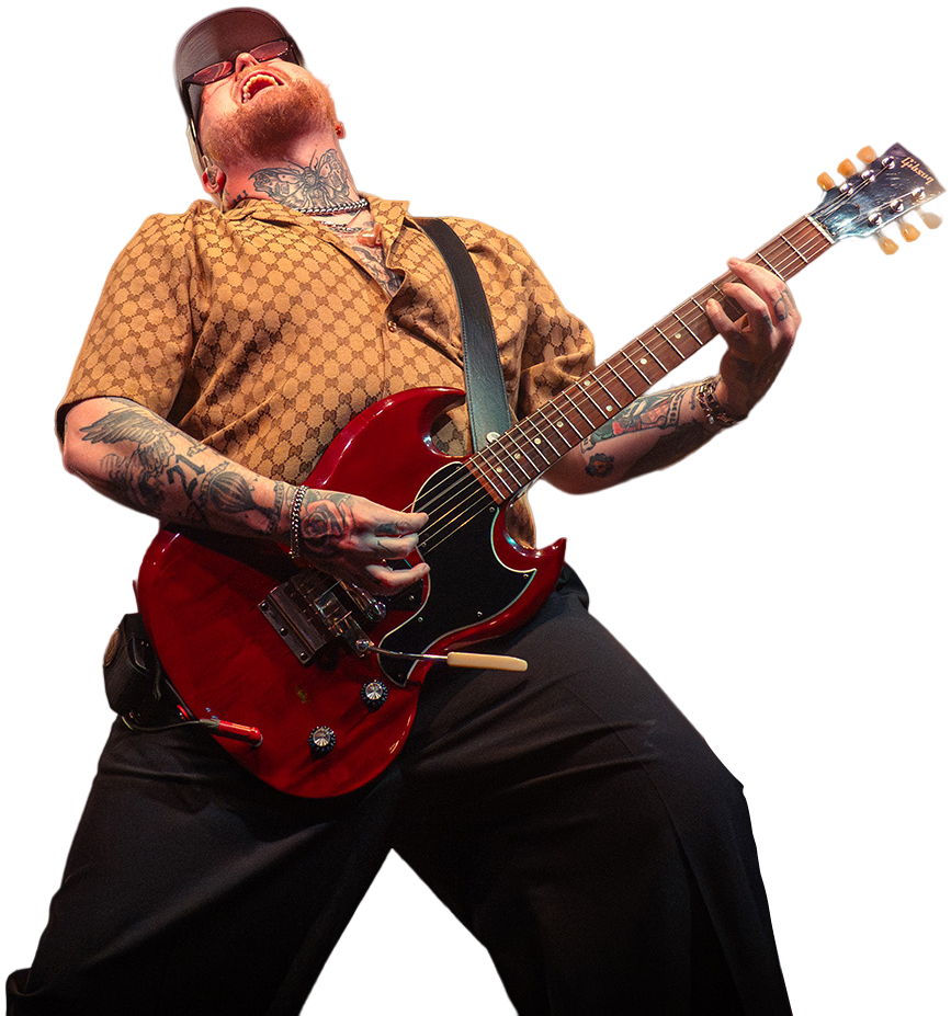 Guitarist playing on stage leaning backwards with a red guitar