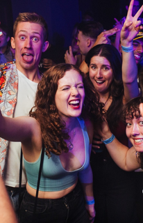 Female student trying to score a point in Netball whilst being blocked by member of the other team
