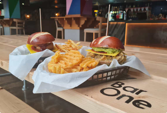 A group of students talking and smiling in a large crowd