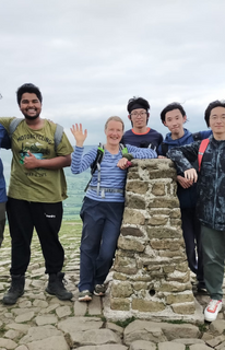 Female student trying to score a point in Netball whilst being blocked by member of the other team